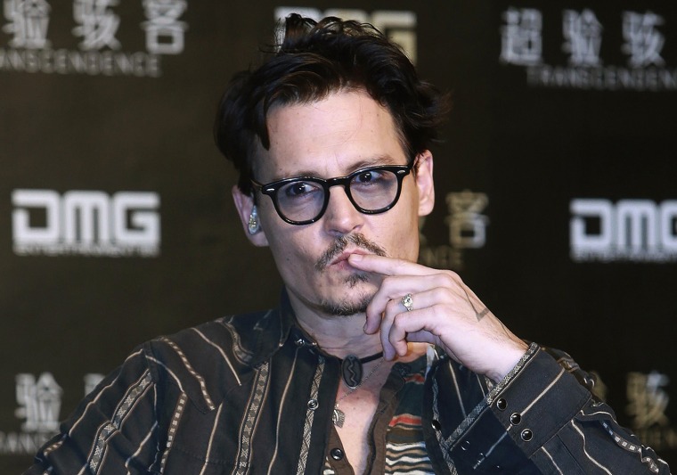 Image: Actor Depp gestures during a promotional event of his new movie \"Transcendence\", on his first visit to China in Beijing